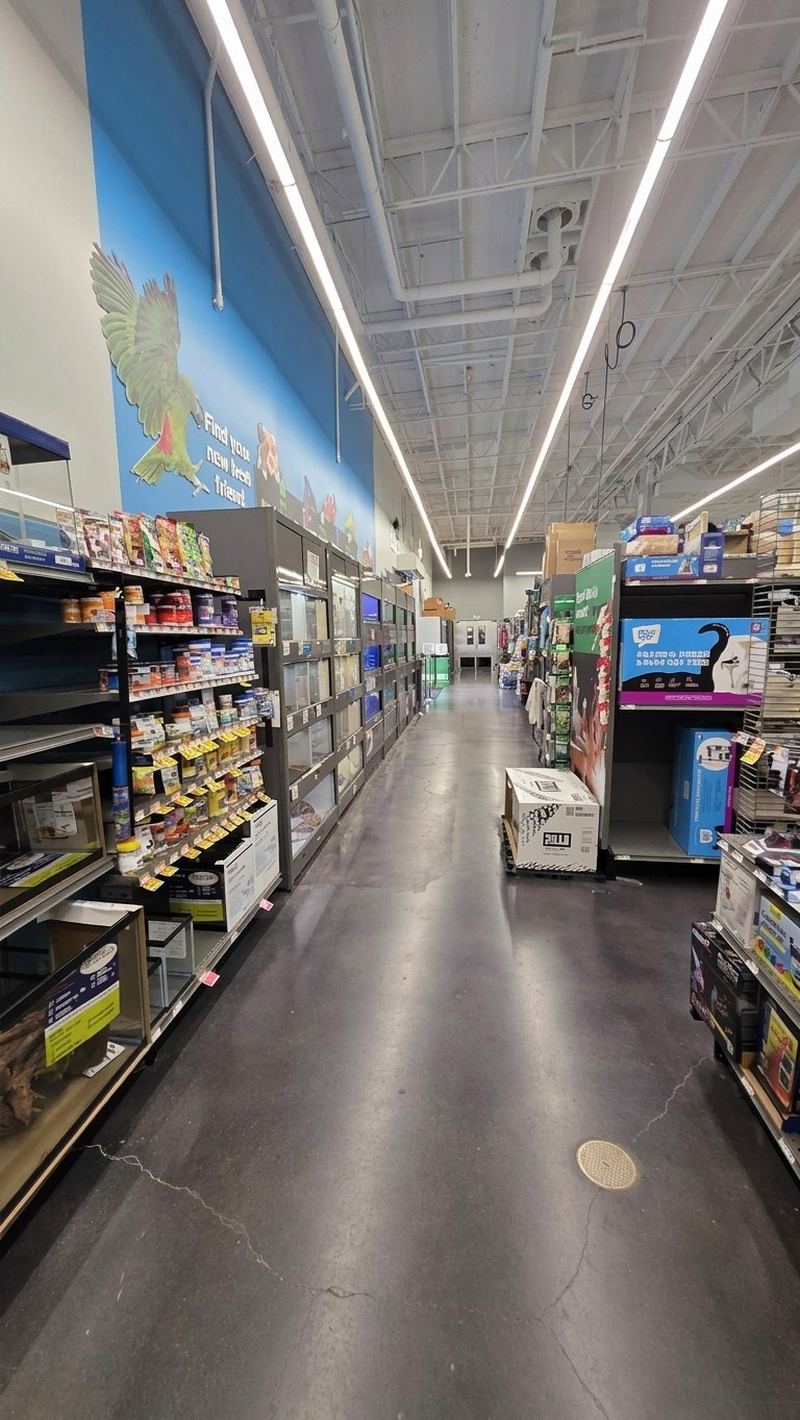 A long aisle with freezers along one side under a painted wall mural
